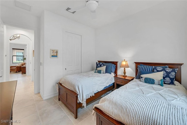 6231 Brunello Ln, Naples, FL 34113 - bedroom with ceiling fan, light tile patterned flooring, visible vents, baseboards, and a closet