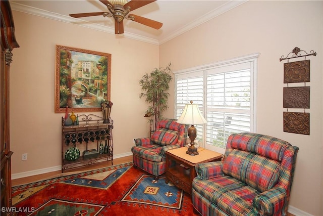 sitting room featuring crown molding, wood-type flooring, and ceiling fan