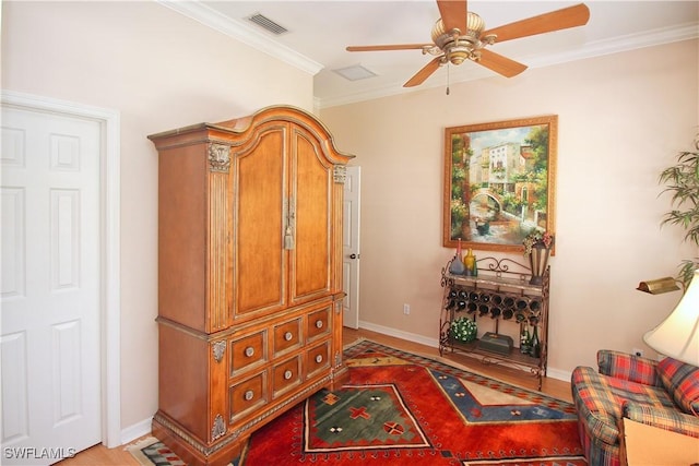 living area featuring ornamental molding, ceiling fan, and light hardwood / wood-style floors