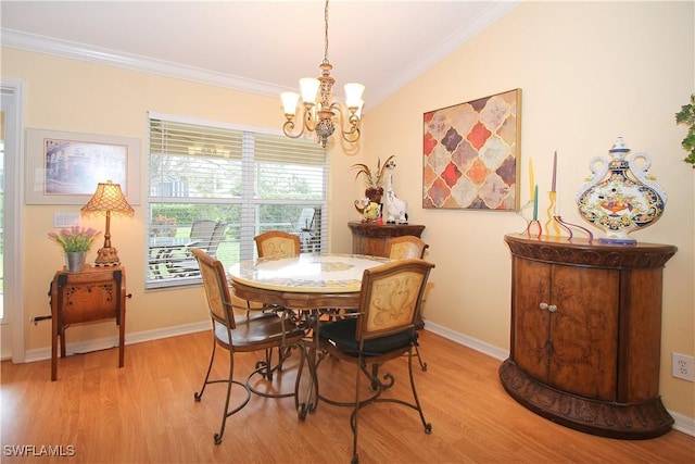 dining area featuring ornamental molding, a chandelier, and light wood-type flooring