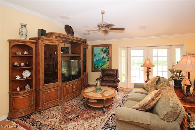 living room featuring wood-type flooring, crown molding, vaulted ceiling, and ceiling fan