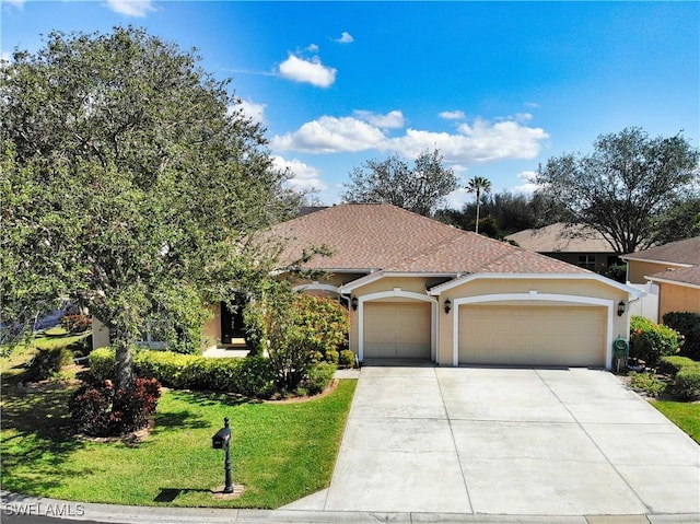 view of front of house with a garage and a front yard