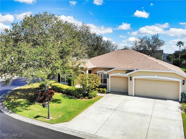 view of front of property with a garage and a front yard