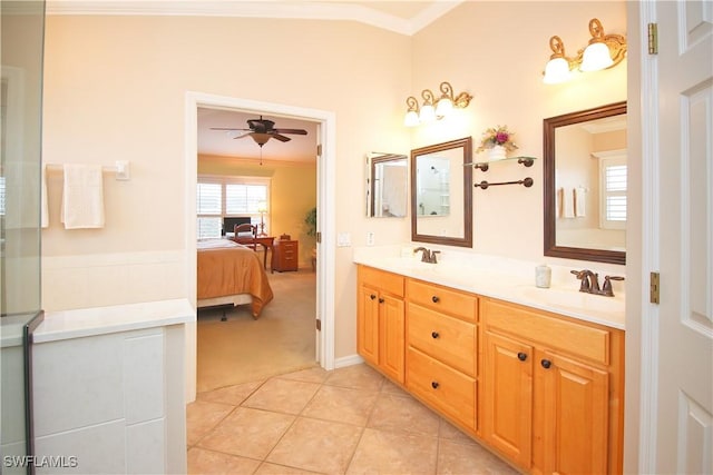 bathroom featuring lofted ceiling, crown molding, vanity, ceiling fan, and tile patterned flooring