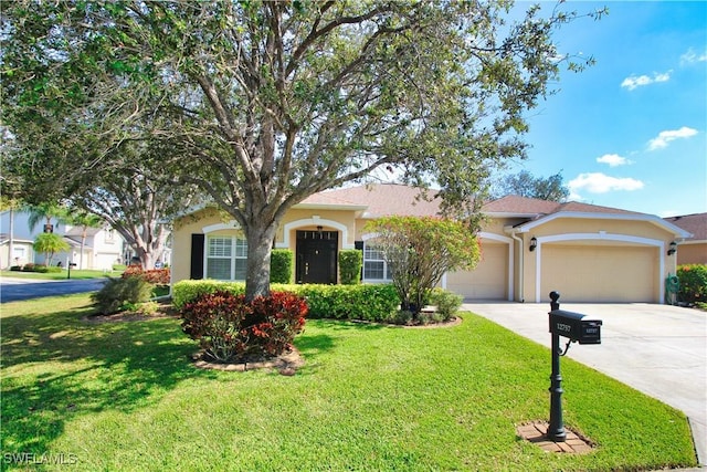 view of front of property with a garage and a front yard