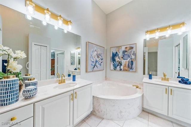 bathroom with two vanities, a closet, tile patterned flooring, and a sink