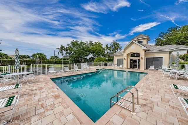 pool featuring a patio and fence