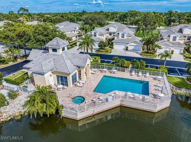 back of property featuring a patio, a residential view, a water view, a community pool, and a community hot tub