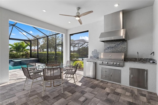 view of patio / terrace with sink, grilling area, an in ground hot tub, and an outdoor kitchen