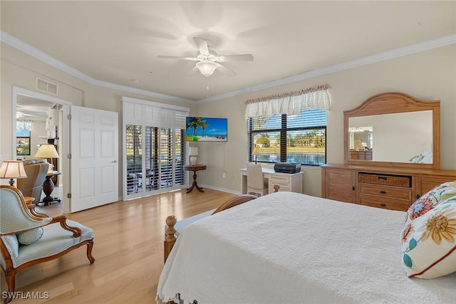 bedroom with a ceiling fan, light wood-type flooring, visible vents, and crown molding