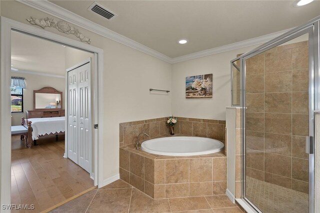 ensuite bathroom with visible vents, crown molding, a shower stall, and a bath