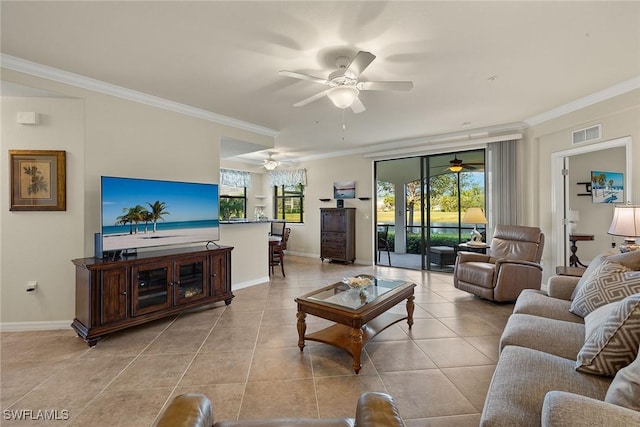 living room with light tile patterned floors, ceiling fan, visible vents, baseboards, and crown molding