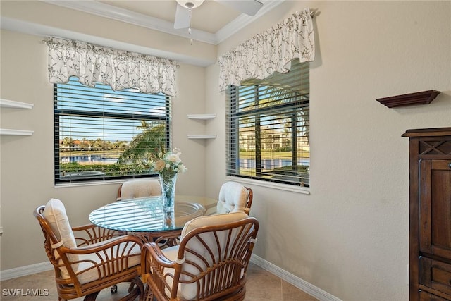 dining area featuring ceiling fan, baseboards, crown molding, and tile patterned floors