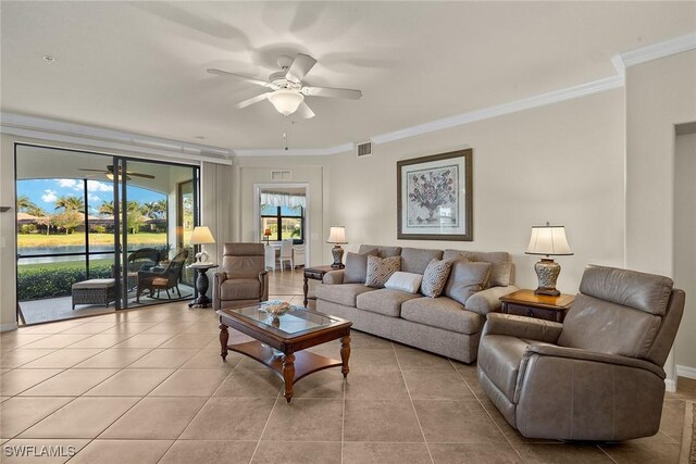 living room featuring crown molding, visible vents, a ceiling fan, and tile patterned floors