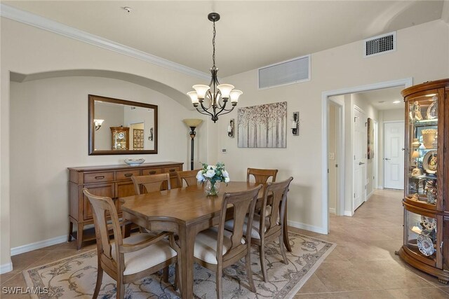 dining room with crown molding, a chandelier, visible vents, and baseboards