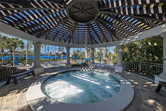 view of swimming pool with a patio area, a hot tub, and a pergola