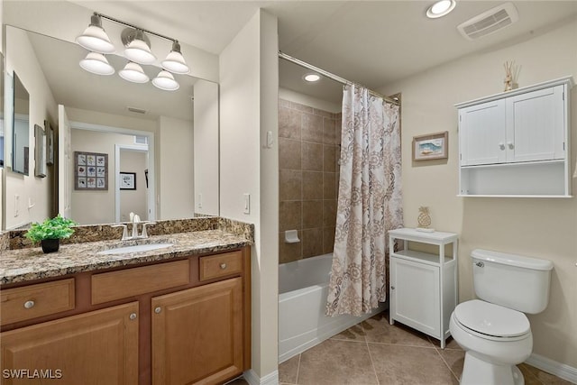 bathroom with tile patterned flooring, toilet, vanity, visible vents, and shower / bath combo with shower curtain