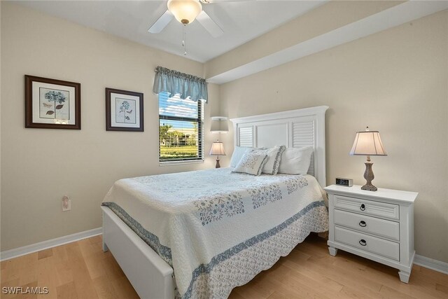 bedroom featuring baseboards, a ceiling fan, and light wood-style floors