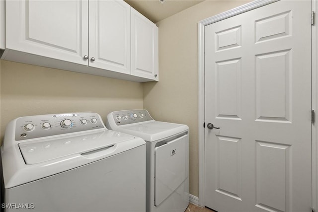 washroom featuring cabinet space and washer and dryer