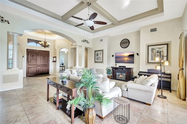 living room with light tile patterned floors, a towering ceiling, ornate columns, and coffered ceiling