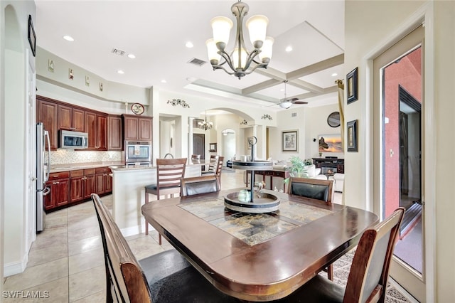 dining room featuring light tile patterned flooring, coffered ceiling, ceiling fan with notable chandelier, and beam ceiling