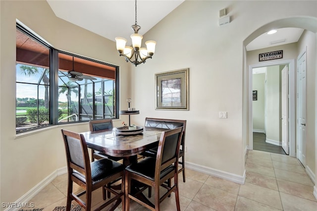 tiled dining room with ceiling fan and vaulted ceiling