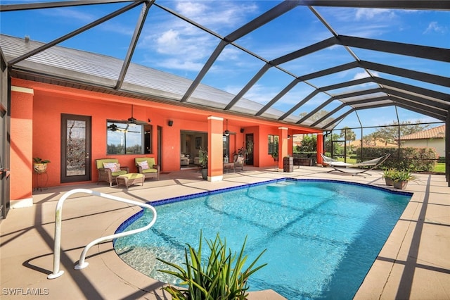 view of swimming pool with a patio area, an outdoor living space, ceiling fan, and a lanai