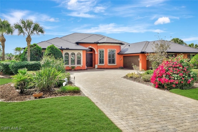 view of front of property with a front lawn and a garage