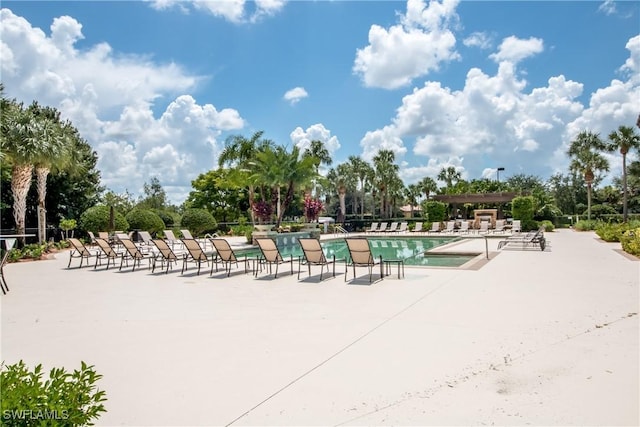 view of property's community featuring a patio area and a swimming pool