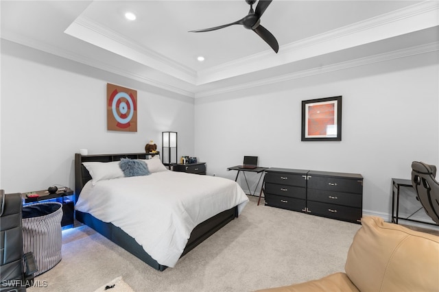 bedroom with a raised ceiling, crown molding, carpet floors, and ceiling fan