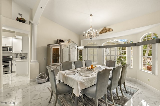 dining room featuring marble finish floor, decorative columns, baseboards, and an inviting chandelier