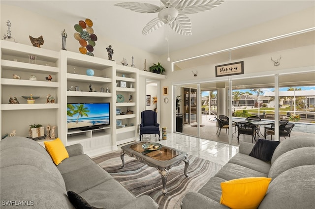 living area featuring built in shelves and a ceiling fan