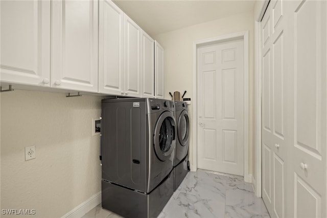 laundry room with marble finish floor, cabinet space, independent washer and dryer, and baseboards