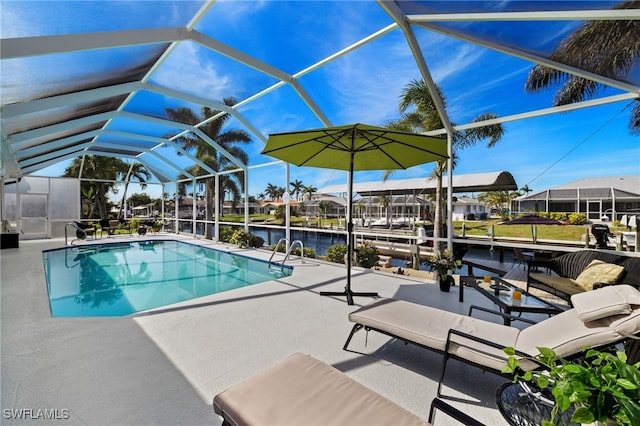 outdoor pool with glass enclosure, a boat dock, a patio area, and a water view