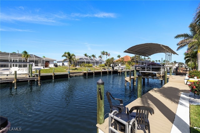 dock area featuring a water view, boat lift, and a residential view