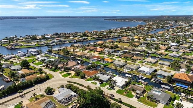 drone / aerial view featuring a water view and a residential view