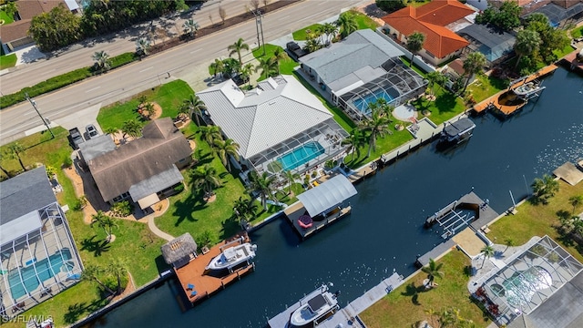 drone / aerial view featuring a water view and a residential view