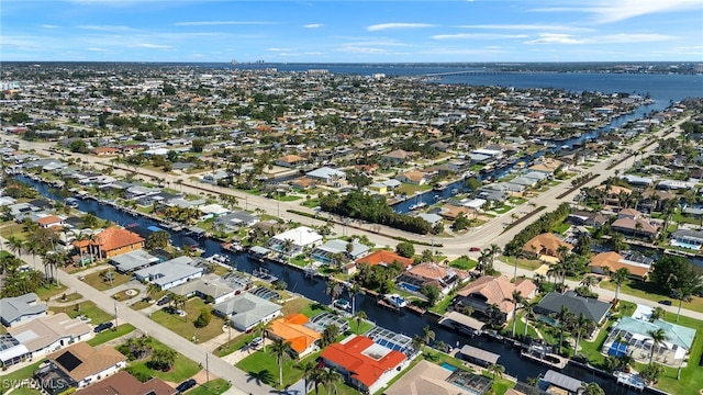 birds eye view of property with a residential view and a water view