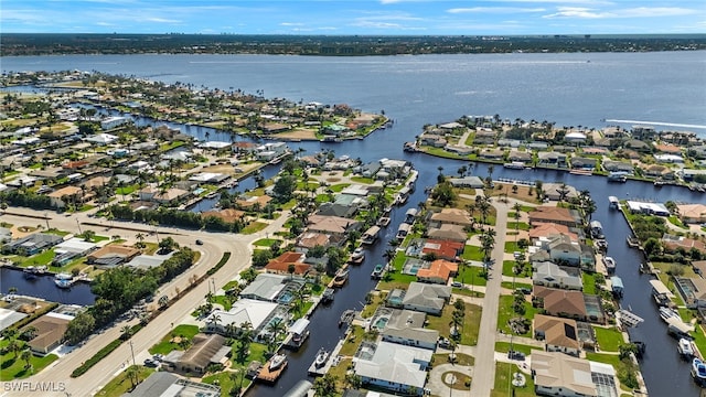 birds eye view of property with a water view and a residential view