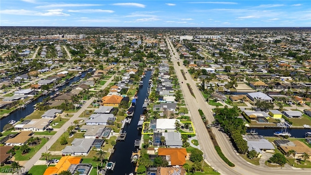 birds eye view of property featuring a residential view and a water view