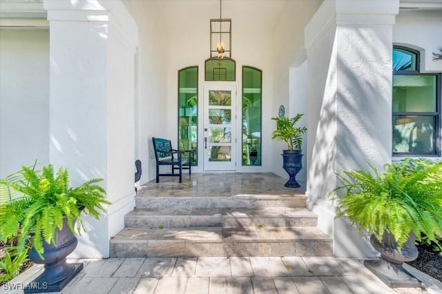 property entrance with french doors and stucco siding