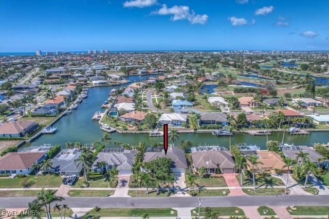 drone / aerial view with a water view and a residential view