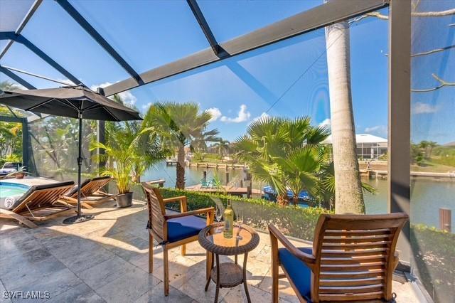 view of patio featuring a lanai and an outdoor pool