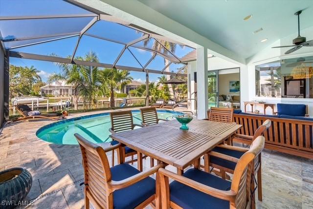 exterior space with a patio, outdoor lounge area, outdoor dining space, ceiling fan, and a lanai