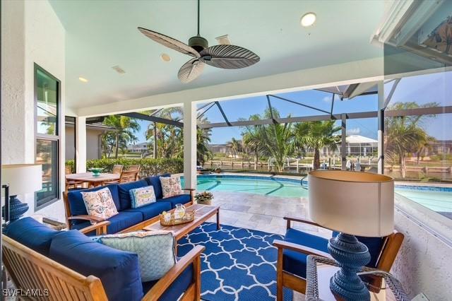 sunroom with a pool and a ceiling fan