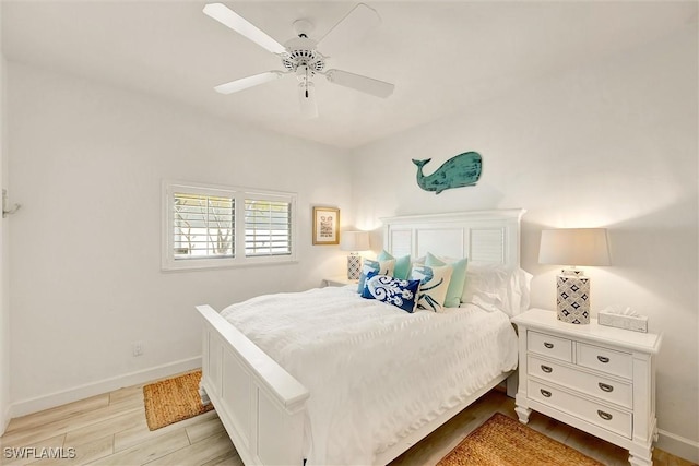 bedroom featuring baseboards, ceiling fan, and light wood-style floors