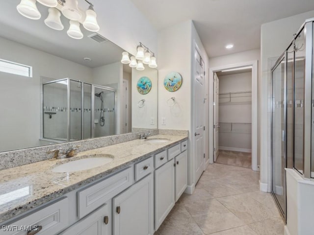 17183 Ashford Ter, Fort Myers, FL 33967 - bathroom featuring vanity, a chandelier, a shower with shower door, and tile patterned floors