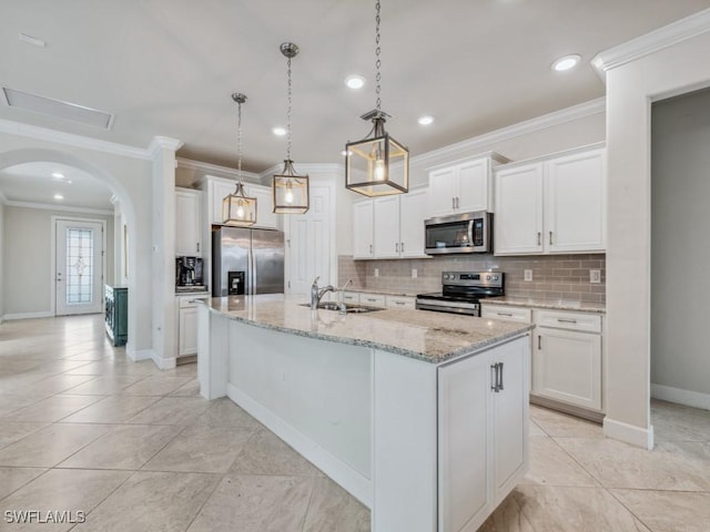 17183 Ashford Ter, Fort Myers, FL 33967 - kitchen with a kitchen island with sink, stainless steel appliances, sink, white cabinets, and pendant lighting
