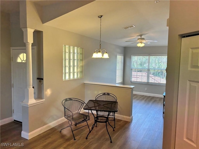 23861 Costa Del Sol Rd Unit 203, Estero, FL 34135 - dining room featuring ceiling fan, baseboards, dark wood finished floors, and decorative columns