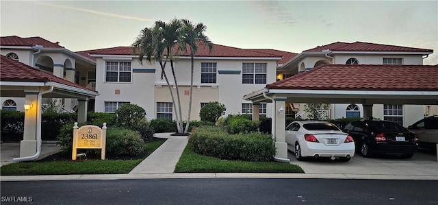 23861 Costa Del Sol Rd Unit 203, Estero, FL 34135 - view of front of home with stucco siding, covered parking, and a tiled roof